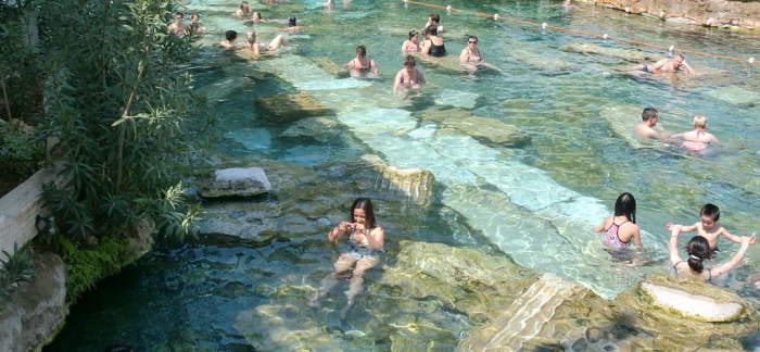 Swimmers in the warm antique pool of Hierapolis, above the Pamukkale terraces