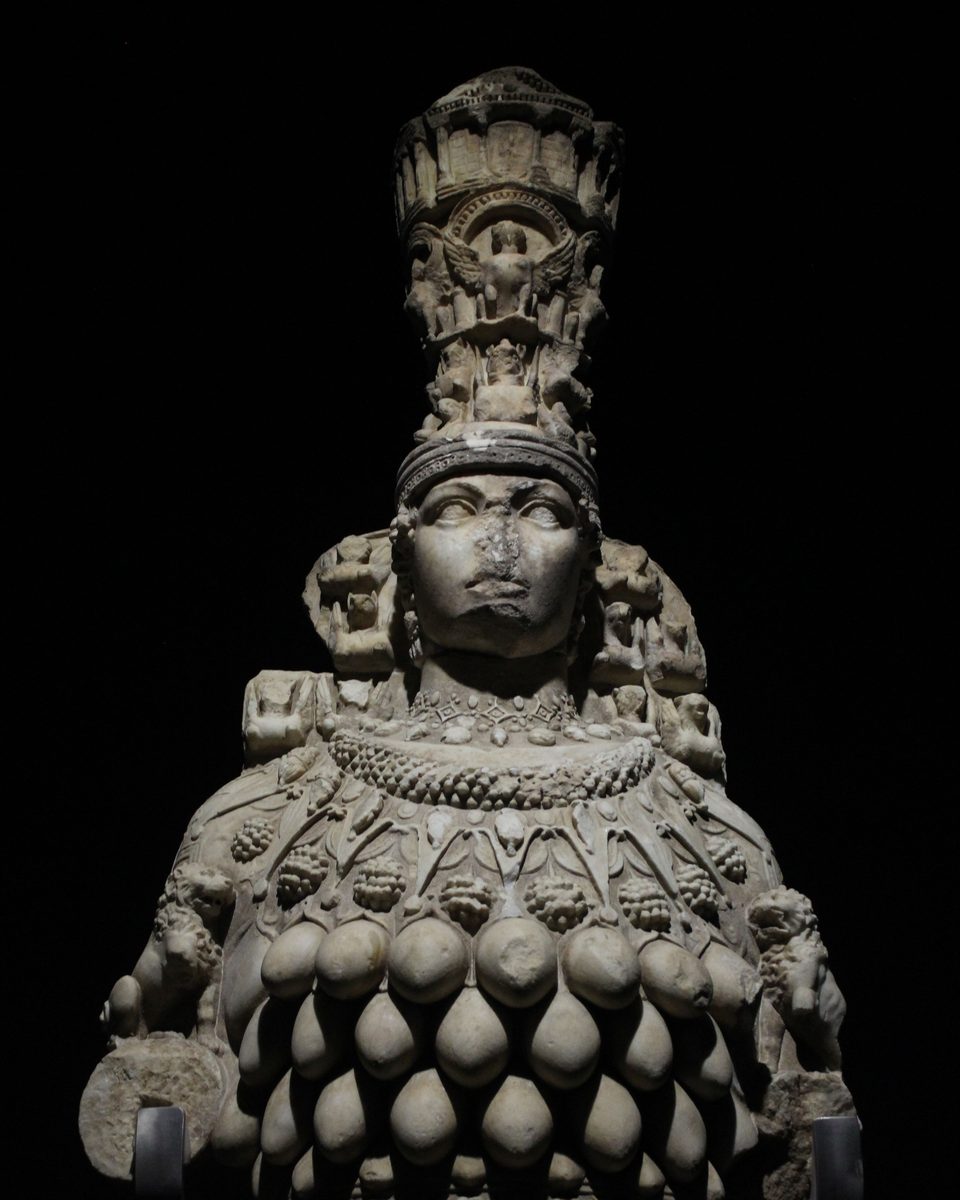 The Great Artemis statue in the Ephesus Museum in Selçuk, with a tall temple-shaped crown, a necklace, and rows of oval forms on her chest