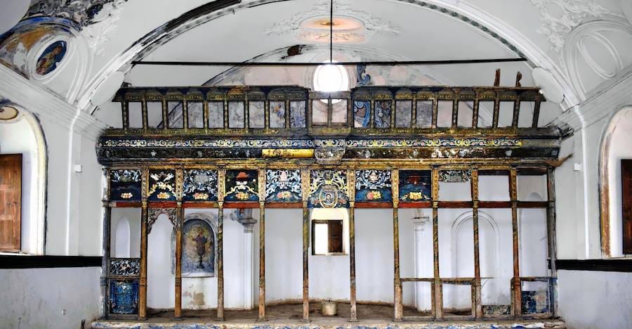 Interior of an old Greek Orthodox church in Şirince with a stripped wooden screen still showing blue and gold painted panels