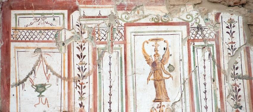 Roman wall fresco in the Terrace Houses of Ephesus with a winged Nike painted between red and green panel borders